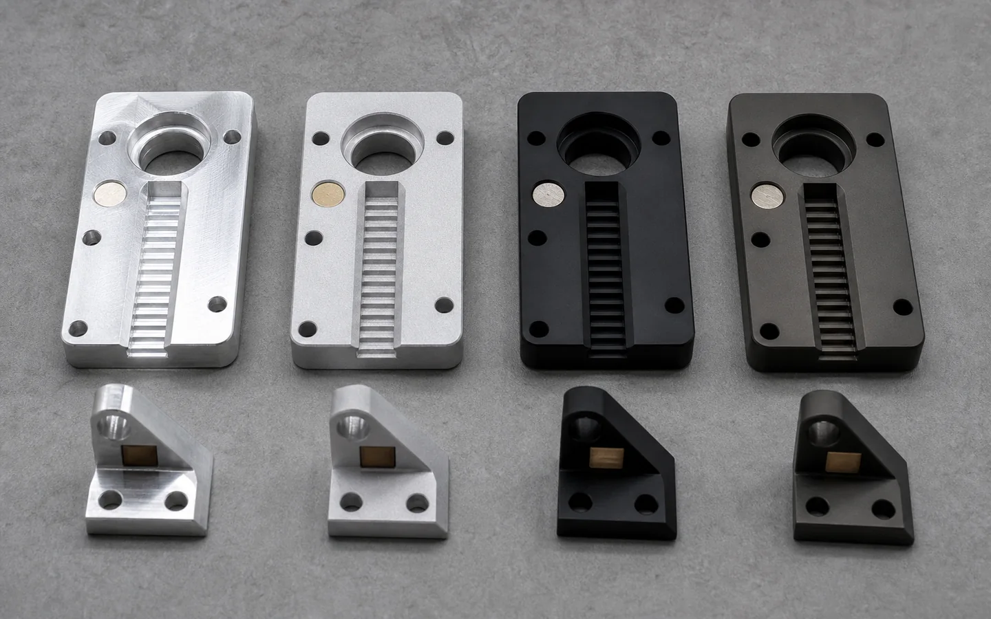 Matching machined aluminum coupons and brackets shown raw, clear, matte black and dark wear-oriented with masked bores and contact points visible.