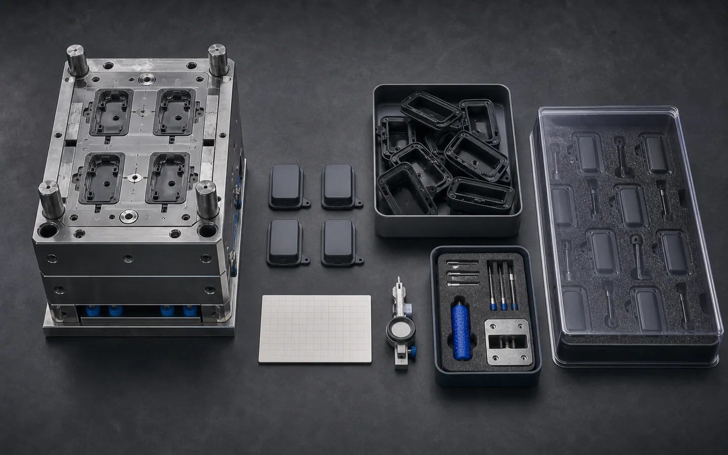 Four-cavity mold, matching molded housings, blank review grid, maintenance tools and protected repeat-part tray.