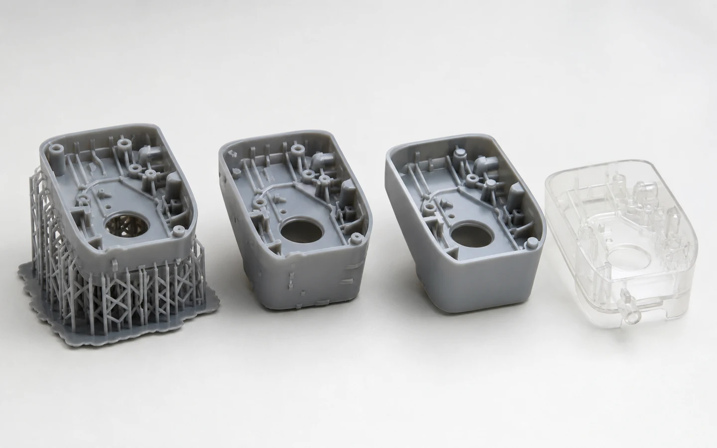 Matching SLA resin covers shown on supports, after support removal and with a smooth presentation finish beside a transparent flow model.